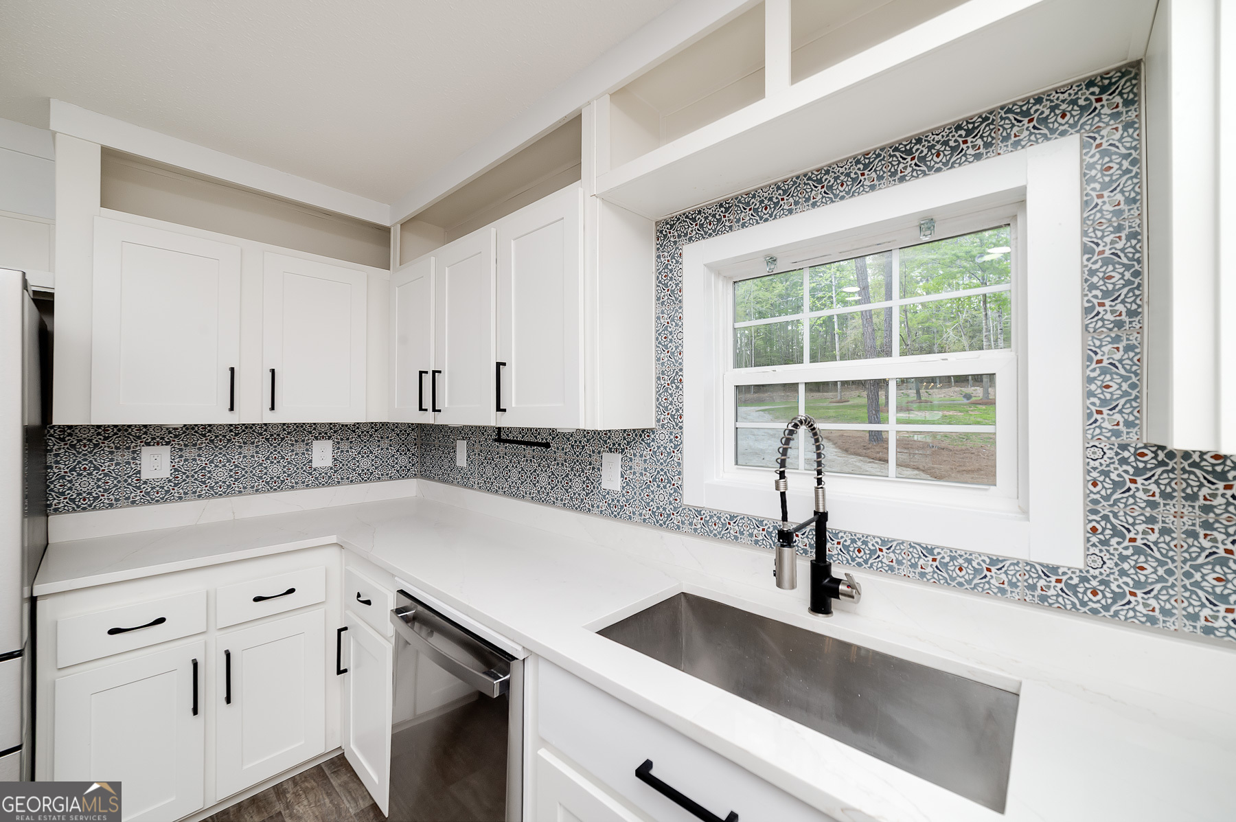595 Barnetts Bridge Road Jackson, GA 30233 - Photo 25 of 47 a kitchen with granite countertop a sink and a window
