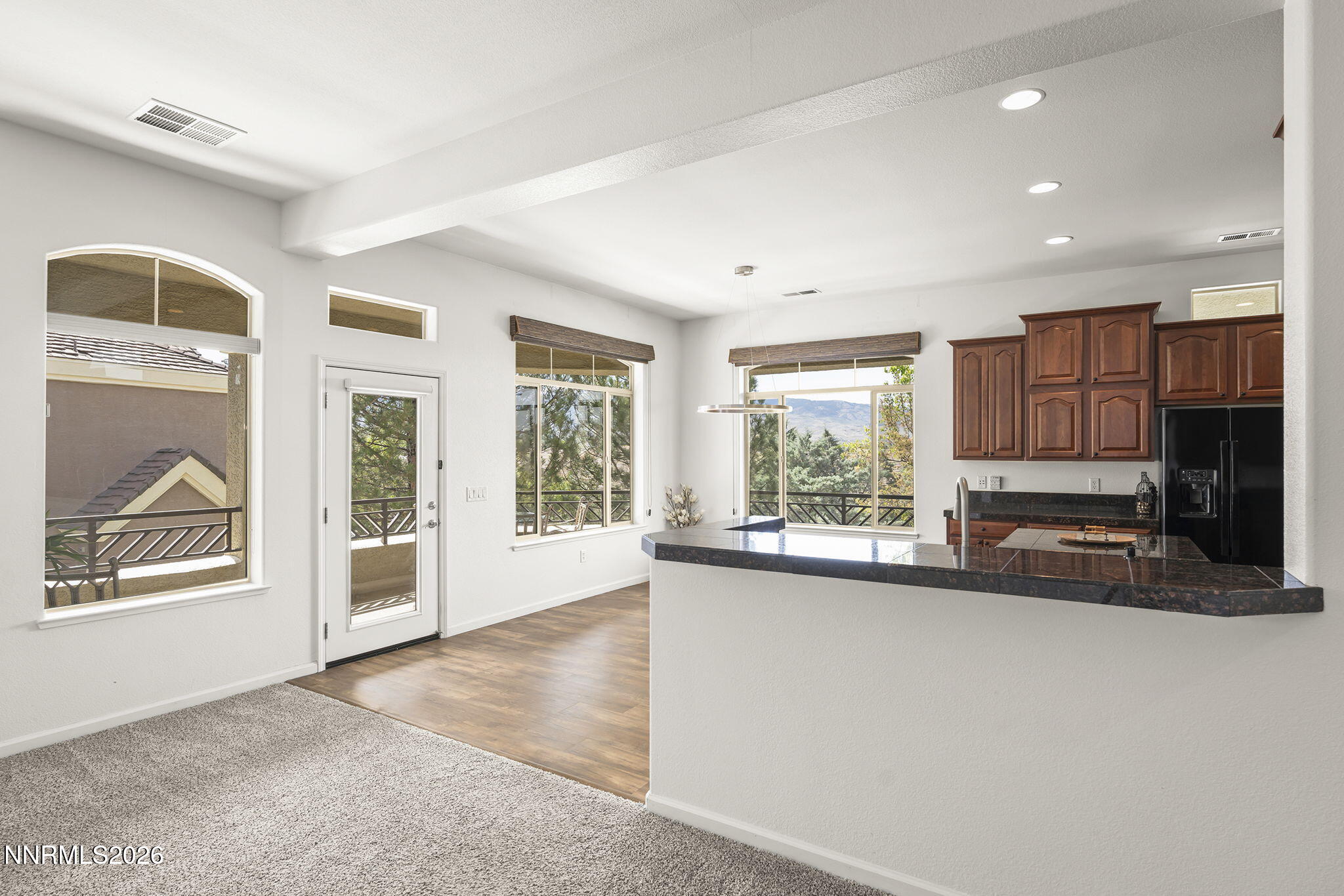 9900 Wilbur May Parkway, Unit 304 Reno, NV 89521 - Photo 12 of 47 a view of a kitchen with a sink and dishwasher with a large window