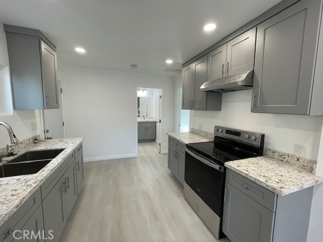 15721 Lakeridge Road, Unit ADU Lake Elsinore, CA 92530 - Photo 1 of 22 a kitchen with a stove sink and cabinets