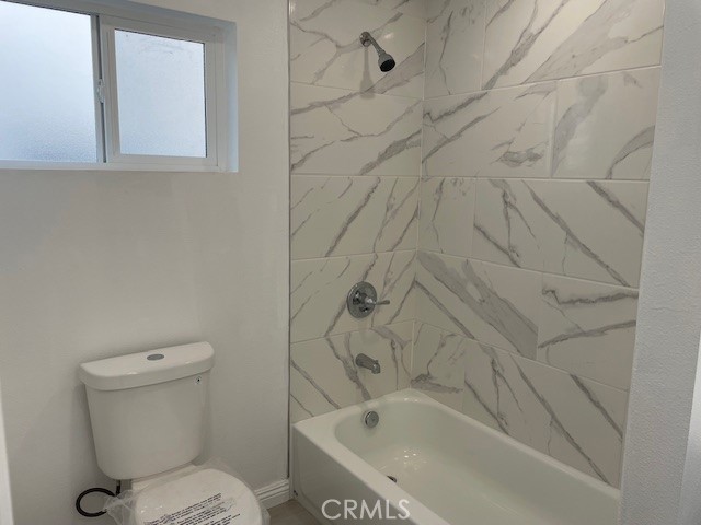 15721 Lakeridge Road, Unit ADU Lake Elsinore, CA 92530 - Photo 15 of 22 a bathroom with a toilet and a bathtub