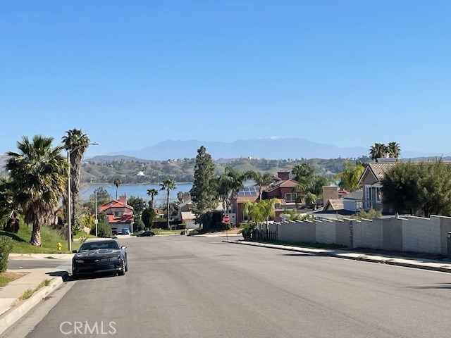 15721 Lakeridge Road, Unit ADU Lake Elsinore, CA 92530 - Photo 21 of 22 a view of a city street with a car parked on the road