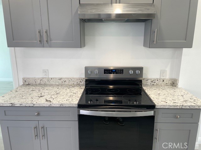 15721 Lakeridge Road, Unit ADU Lake Elsinore, CA 92530 - Photo 3 of 22 a stove top oven sitting inside of a kitchen
