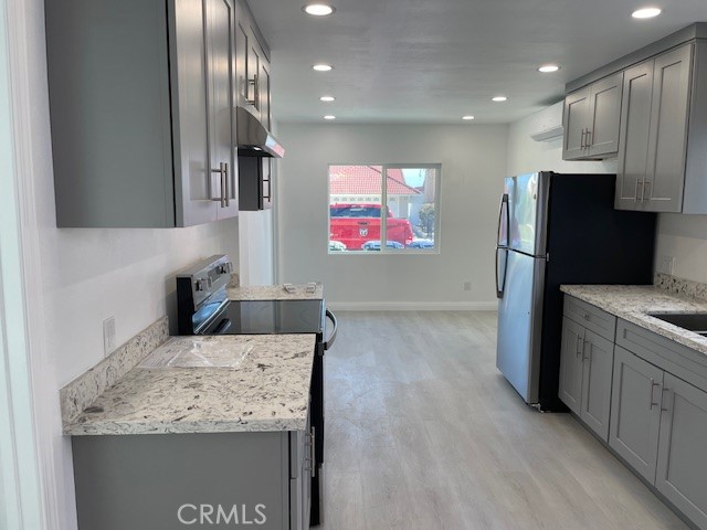 15721 Lakeridge Road, Unit ADU Lake Elsinore, CA 92530 - Photo 4 of 22 a kitchen with stainless steel appliances granite countertop a refrigerator and a sink
