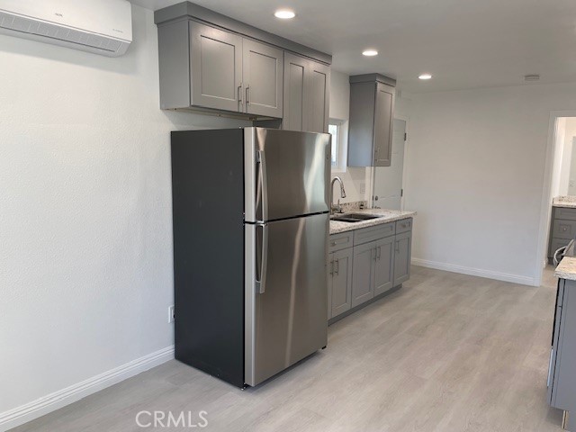 15721 Lakeridge Road, Unit ADU Lake Elsinore, CA 92530 - Photo 6 of 22 a kitchen with stainless steel appliances granite countertop a refrigerator a sink and a stove
