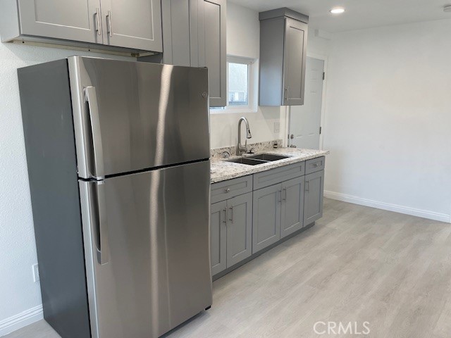 15721 Lakeridge Road, Unit ADU Lake Elsinore, CA 92530 - Photo 7 of 22 a kitchen with stainless steel appliances granite countertop a refrigerator and a sink