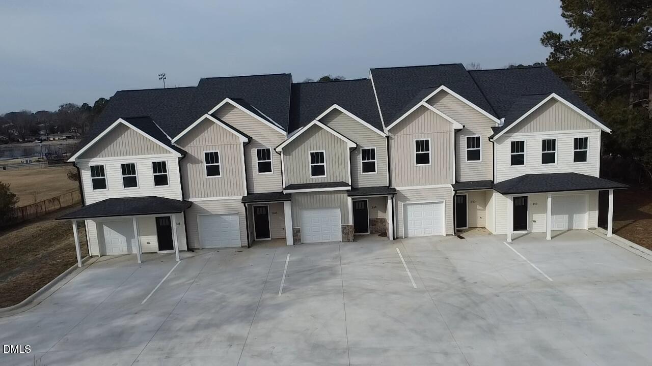 249 North Hickory Street Angier, NC 27501 - Photo 4 of 4 a view of a house with a yard and large trees