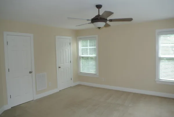 a view of a livingroom with a ceiling fan and window