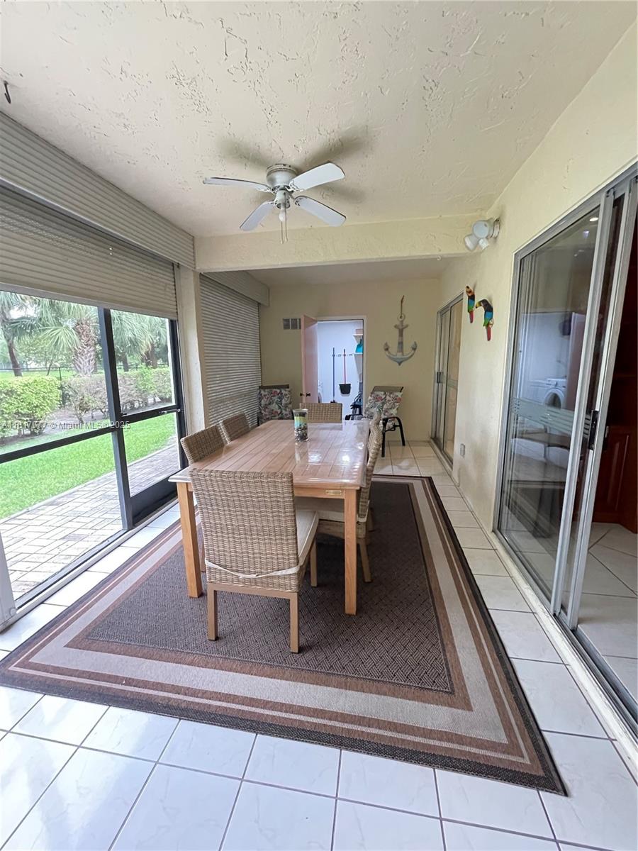 4000 Crystal Lake Drive, Unit 111 Deerfield Beach, FL 33064 - Photo 13 of 26 a dining room with furniture and a floor to ceiling window