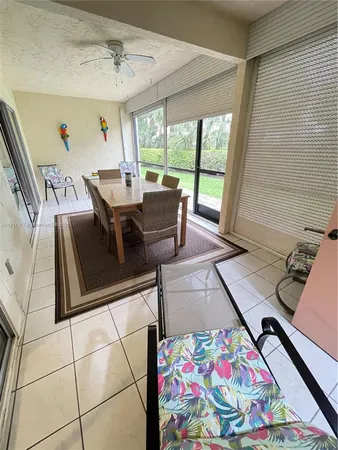 a view of a dining room with furniture and a window