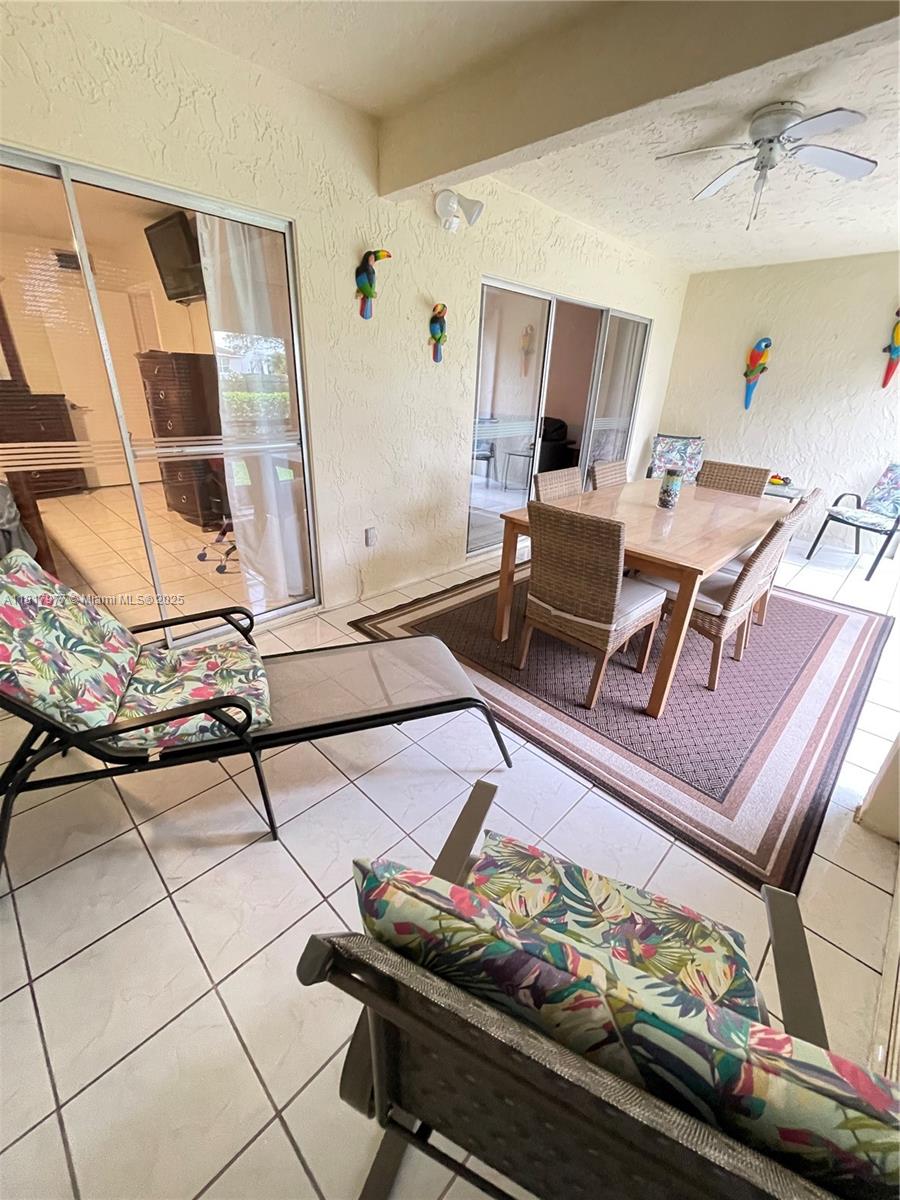 4000 Crystal Lake Drive, Unit 111 Deerfield Beach, FL 33064 - Photo 15 of 26 a living room with furniture and floor to ceiling window