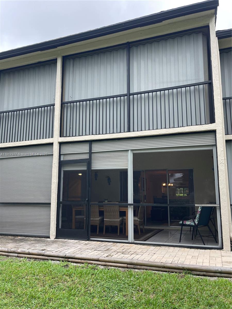 4000 Crystal Lake Drive, Unit 111 Deerfield Beach, FL 33064 - Photo 17 of 26 a view of a house with a large window and plants