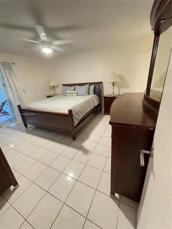 a spacious bedroom with a bed and a shower