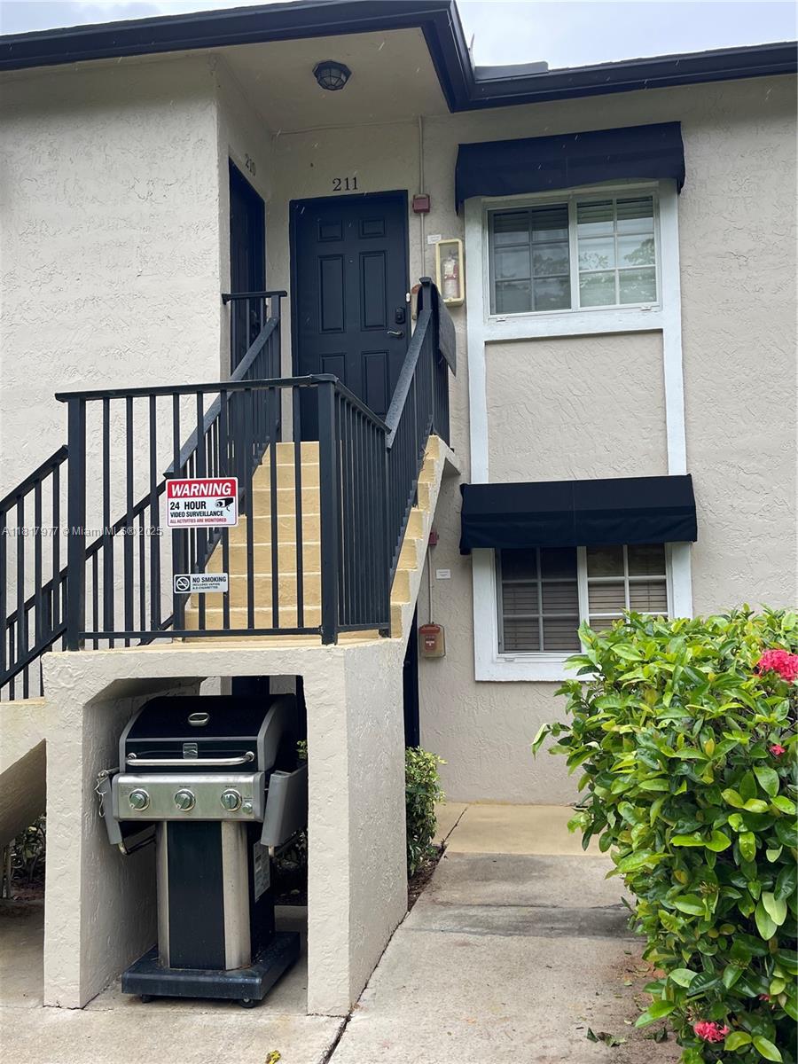 4000 Crystal Lake Drive, Unit 111 Deerfield Beach, FL 33064 - Photo 2 of 26 a view of front door of house with stairs