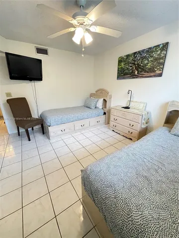 a bedroom with a bed and a television