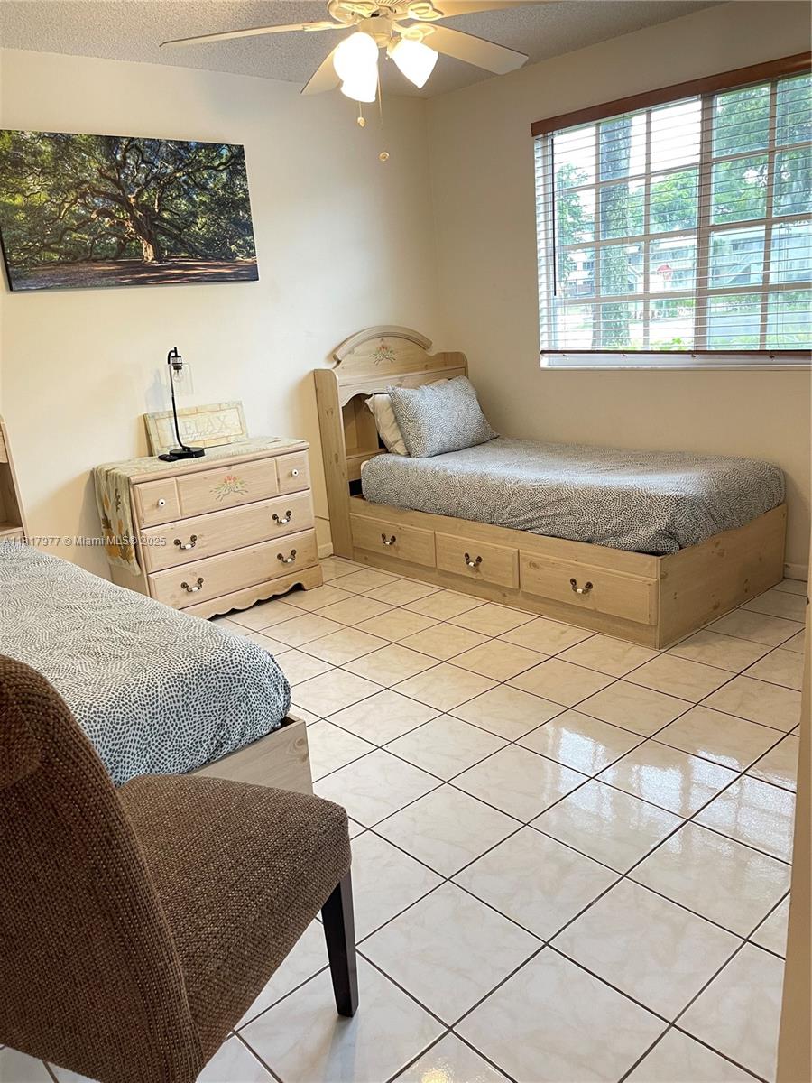 4000 Crystal Lake Drive, Unit 111 Deerfield Beach, FL 33064 - Photo 22 of 26 a bedroom with a bed and a window