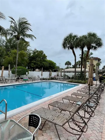 a view of swimming pool with a table and chairs