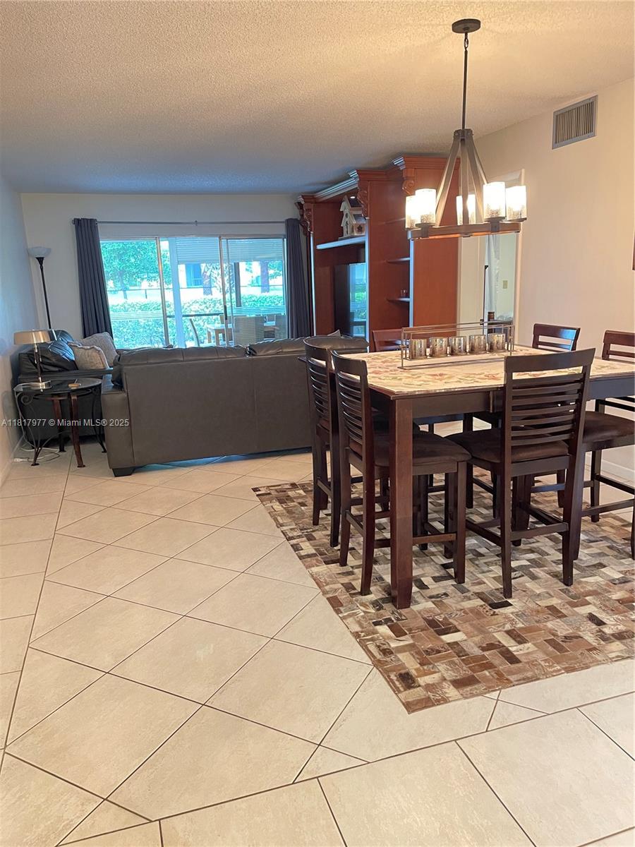 4000 Crystal Lake Drive, Unit 111 Deerfield Beach, FL 33064 - Photo 8 of 26 a view of a dining room with furniture