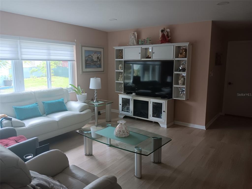 833 Channing Road Lakeland, FL 33805 - Photo 8 of 16 a living room with furniture a flat screen tv and a fireplace