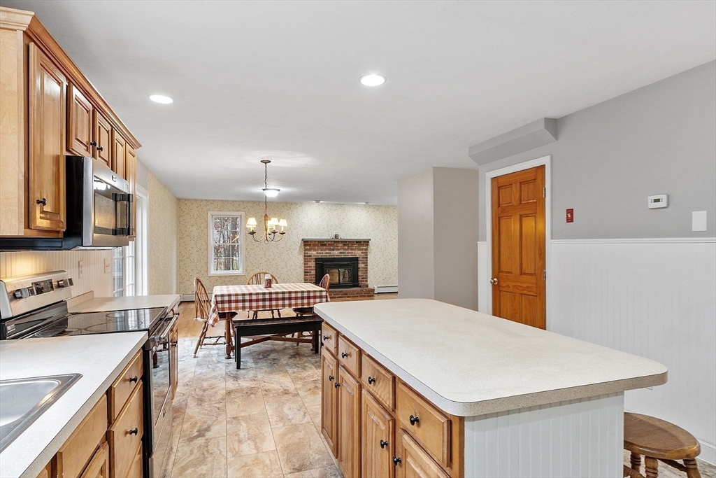 32 Simonds Hill Road Hubbardston, MA 01452 - Photo 11 of 42 a kitchen with a stove a sink a microwave and a refrigerator