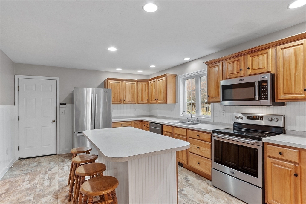 32 Simonds Hill Road Hubbardston, MA 01452 - Photo 12 of 42 a kitchen that has a sink stainless steel appliances a counter space and a window