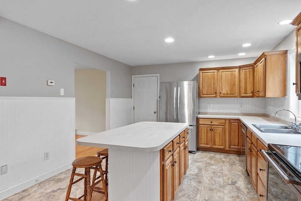 32 Simonds Hill Road Hubbardston, MA 01452 - Photo 13 of 42 a kitchen with a sink a stove cabinets and wooden floor
