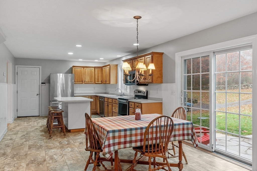 32 Simonds Hill Road Hubbardston, MA 01452 - Photo 15 of 42 a kitchen that has a table chairs in it and wooden floors