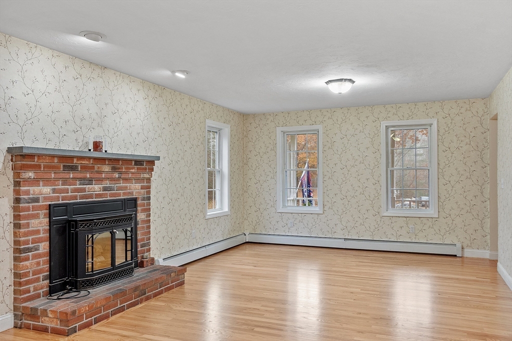 32 Simonds Hill Road Hubbardston, MA 01452 - Photo 17 of 42 an empty room with windows and fireplace
