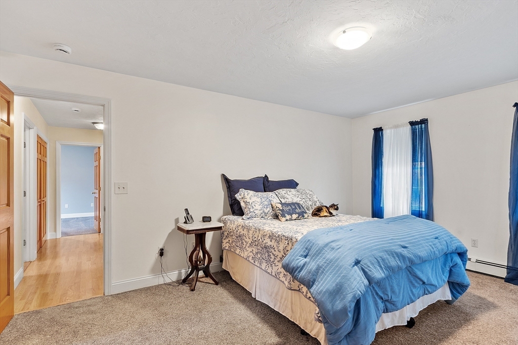 32 Simonds Hill Road Hubbardston, MA 01452 - Photo 27 of 42 a bedroom with a bed and a mirror