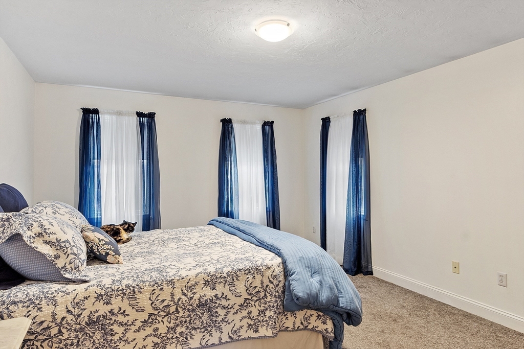 32 Simonds Hill Road Hubbardston, MA 01452 - Photo 29 of 42 a bedroom with a large bed and a closet