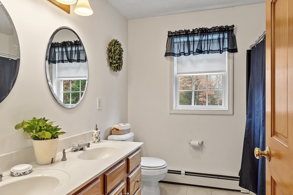 32 Simonds Hill Road Hubbardston, MA 01452 - Photo 30 of 42 a bathroom with a toilet a sink and mirror