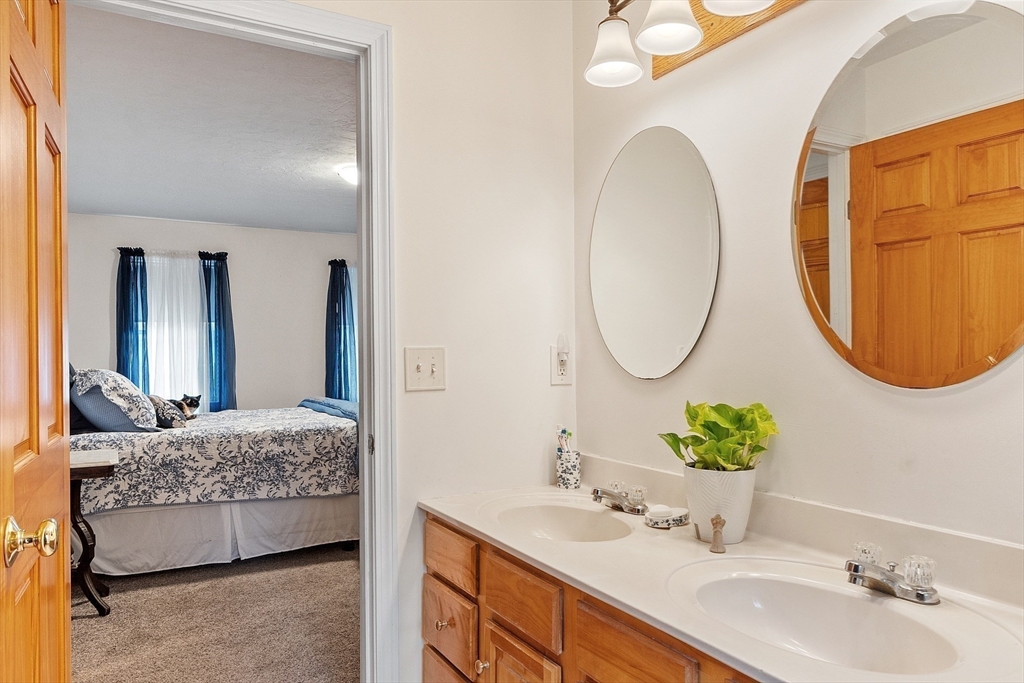 32 Simonds Hill Road Hubbardston, MA 01452 - Photo 31 of 42 a en suite bathroom with a double vanity sink and a mirror