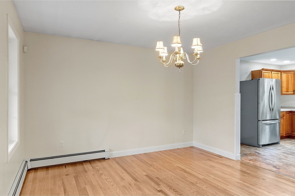 32 Simonds Hill Road Hubbardston, MA 01452 - Photo 8 of 42 a view of a chandelier fan and wooden floor