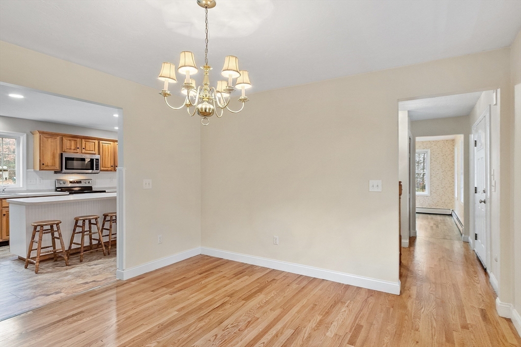 32 Simonds Hill Road Hubbardston, MA 01452 - Photo 9 of 42 a view of a kitchen with wooden floor and a chandelier
