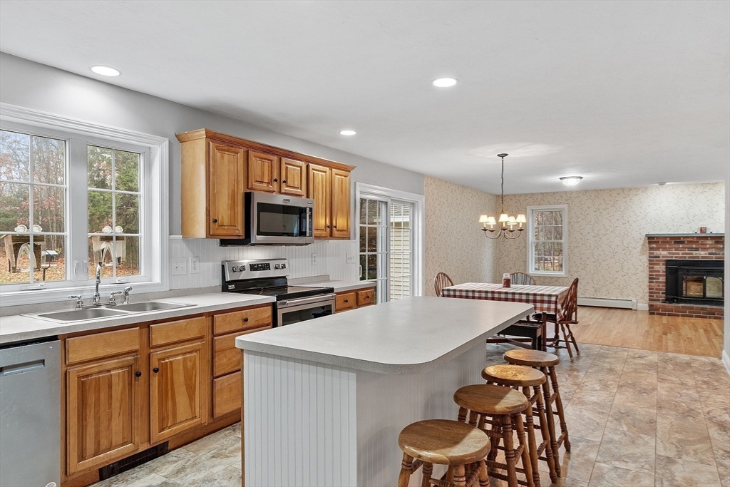 32 Simonds Hill Road Hubbardston, MA 01452 - Photo 10 of 42 a kitchen with stainless steel appliances a table and chairs in it
