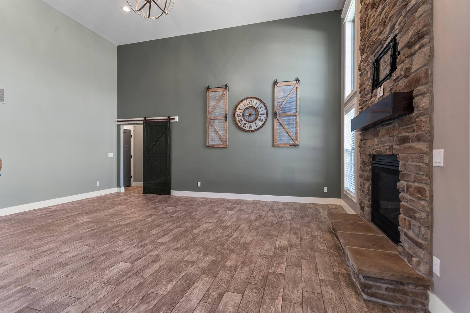 1101 Cascade Drive Savoy, IL 61874 - Photo 11 of 55 a view of an empty room with wooden floor and a fireplace