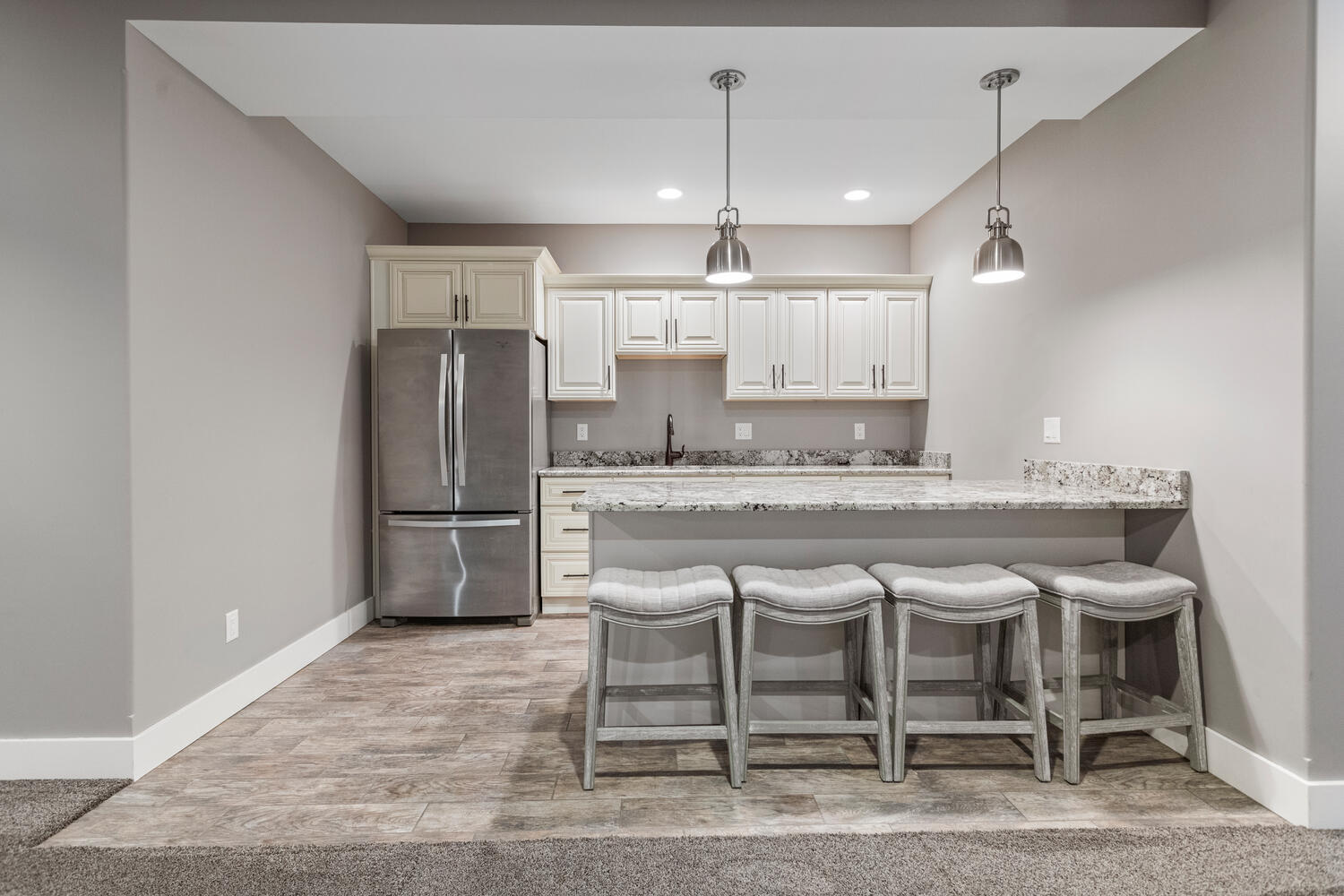 1101 Cascade Drive Savoy, IL 61874 - Photo 38 of 55 a kitchen with kitchen island granite countertop a refrigerator and a stove top oven