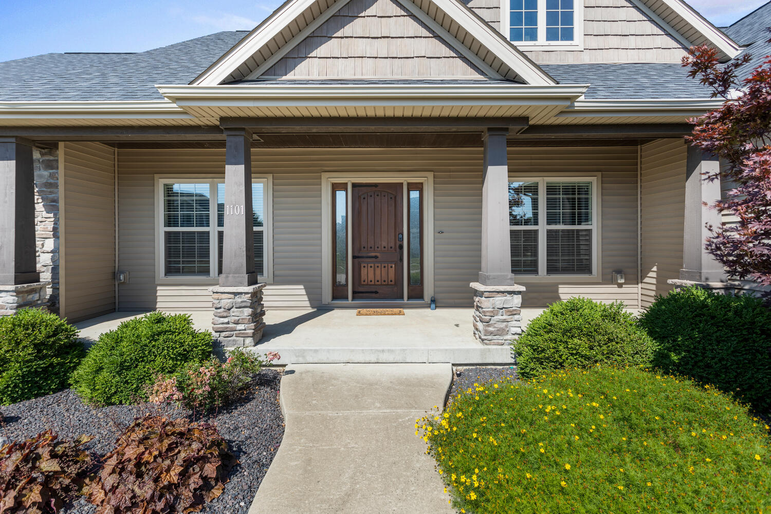 1101 Cascade Drive Savoy, IL 61874 - Photo 6 of 55 a front view of a house with garden