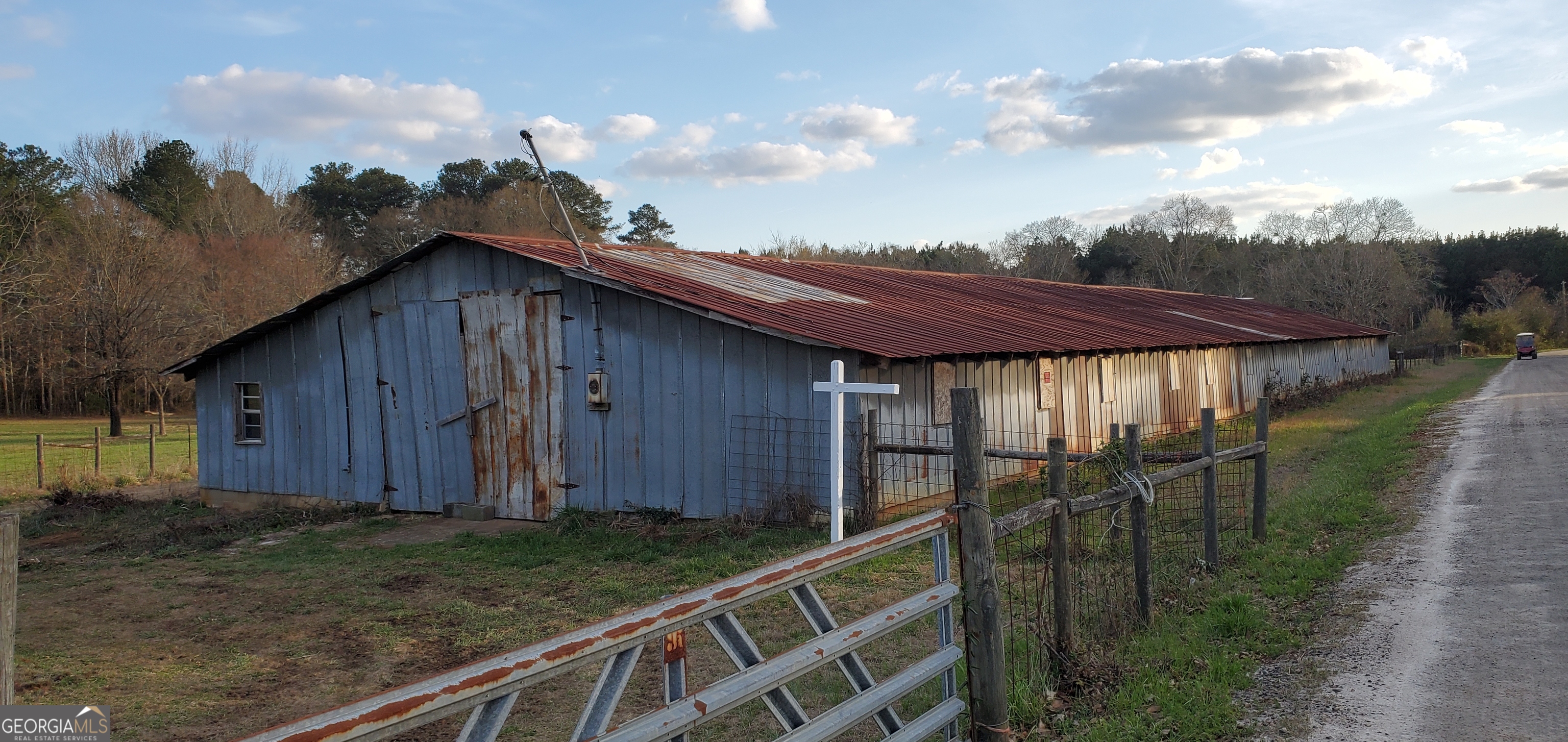 1135 Burger Road Watkinsville, GA 30677 - Photo 2 of 20 a view of backyard with potted plants and wooden fence