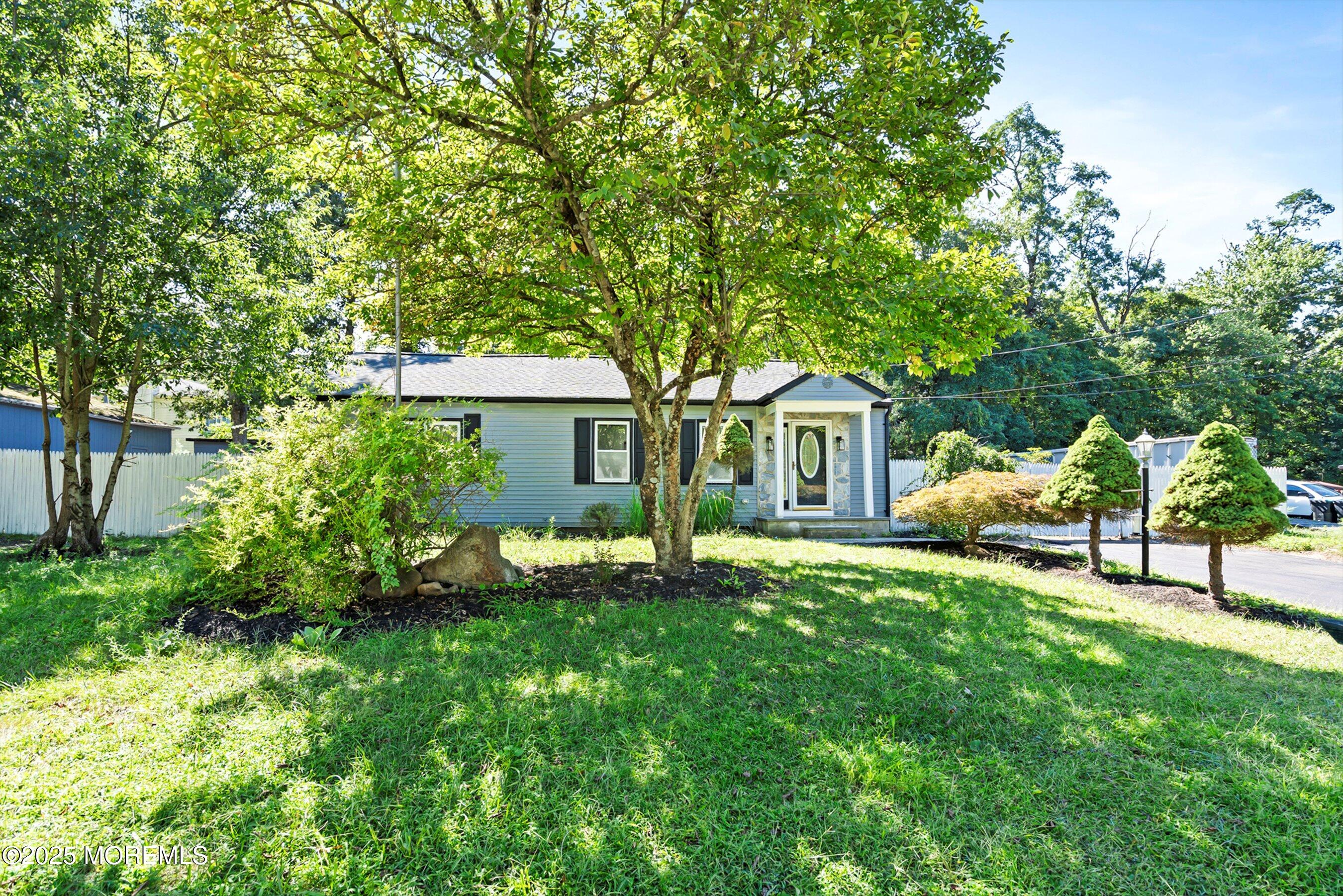 a house view with a sitting space and garden