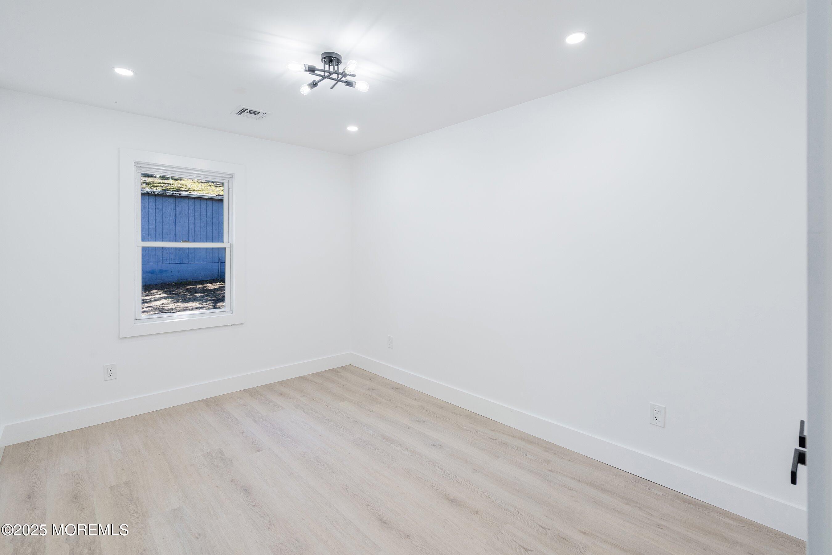 11 Malsbury Lane Cream Ridge, NJ 08514 - Photo 12 of 17 a view of a room with wooden floor and chandelier fan