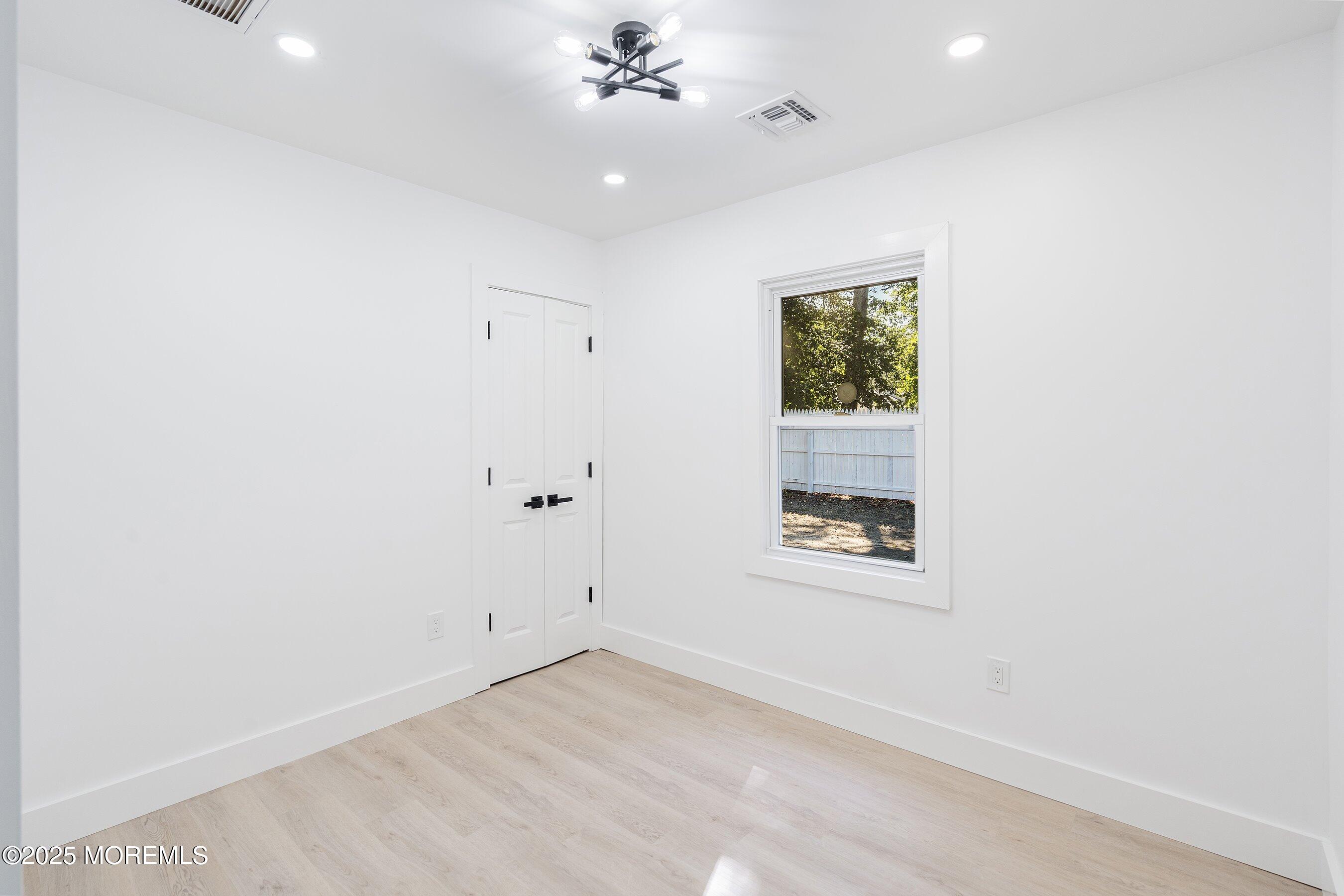 11 Malsbury Lane Cream Ridge, NJ 08514 - Photo 13 of 17 an empty room with a window and a ceiling fan