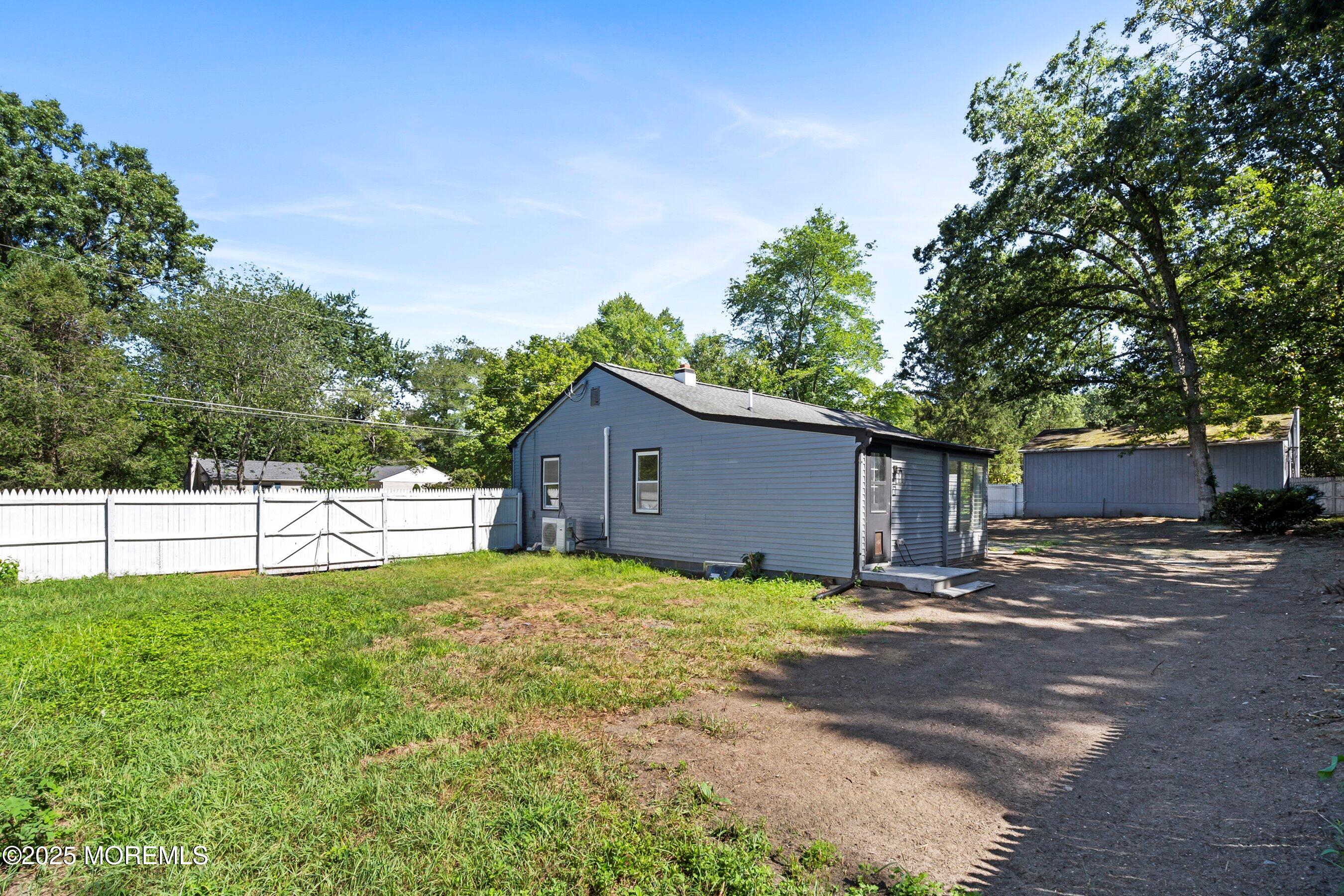 11 Malsbury Lane Cream Ridge, NJ 08514 - Photo 17 of 17 a backyard of a house with large trees and wooden fence