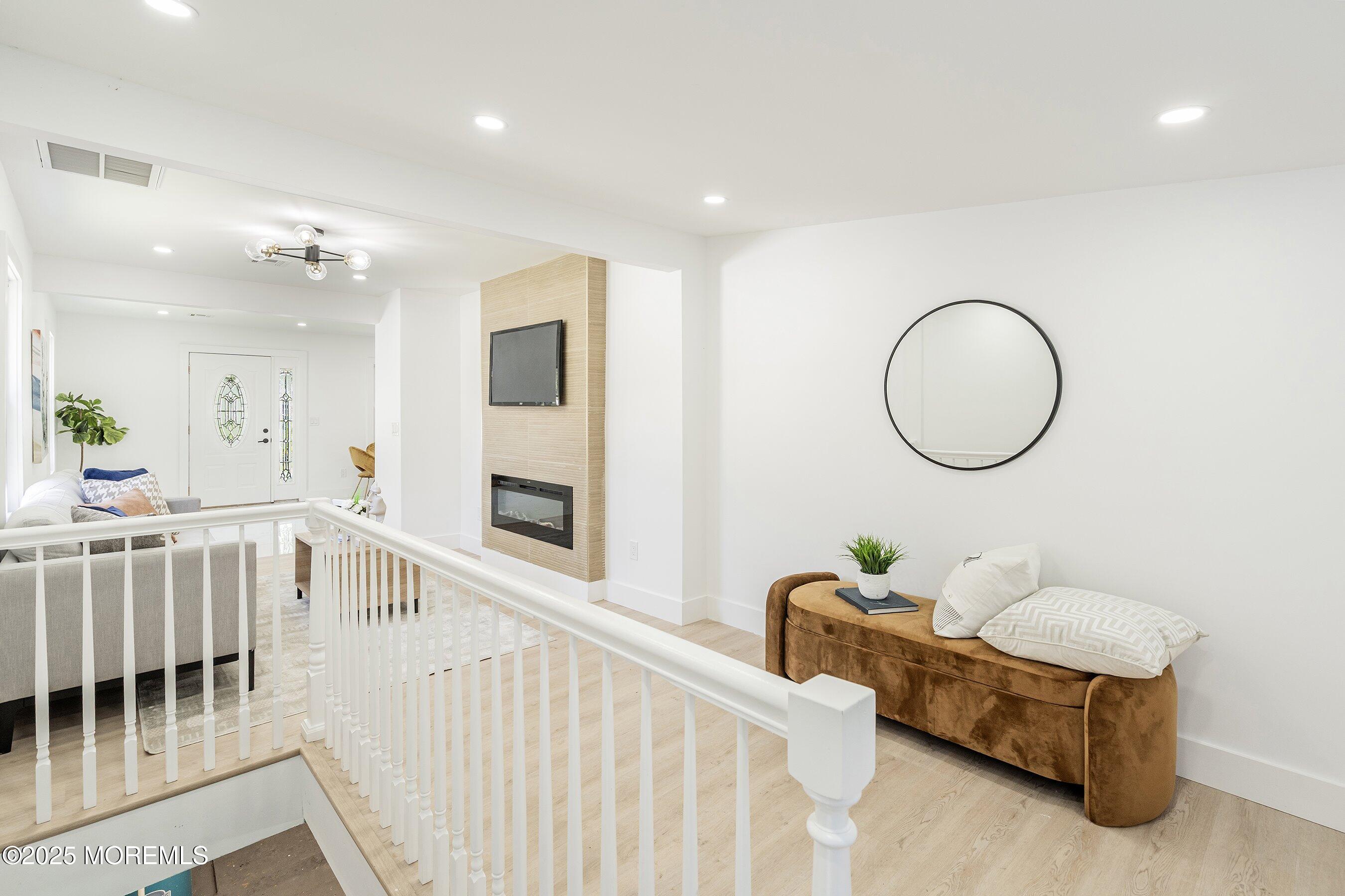 11 Malsbury Lane Cream Ridge, NJ 08514 - Photo 7 of 17 a living room with furniture a mirror and a wooden floor