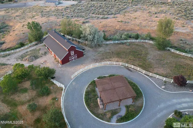 an aerial view of a house with outdoor space and lake view