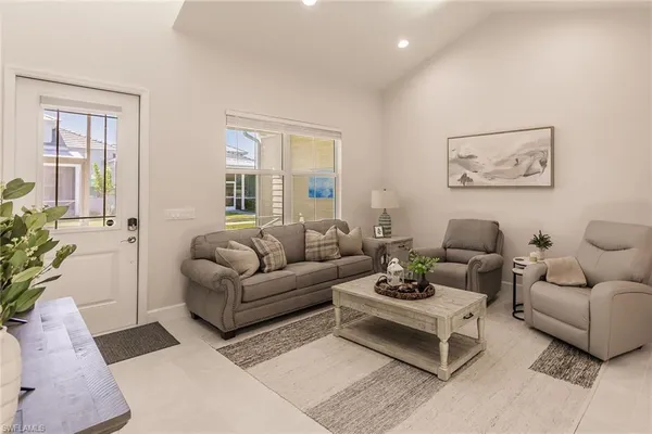 a living room with furniture potted plant and a window