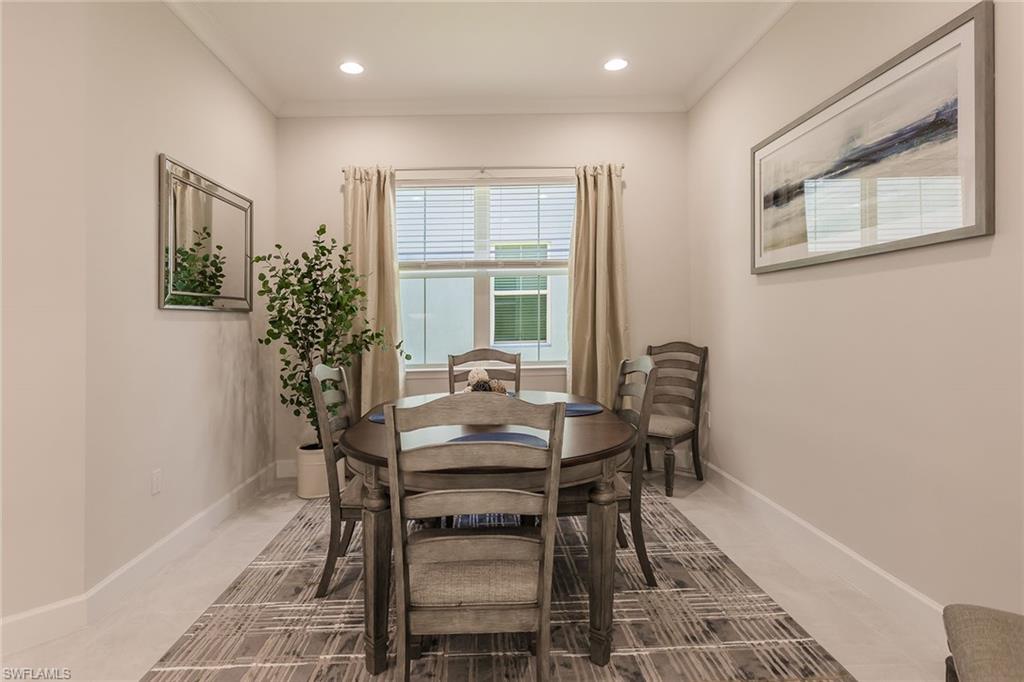 7263 Cayo Coco Lane Naples, FL 34113 - Photo 20 of 44 a view of a dining room with furniture and a potted plant