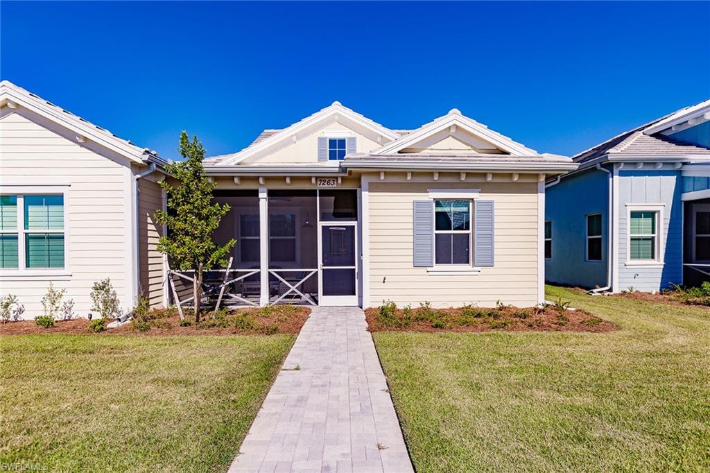 7263 Cayo Coco Lane Naples, FL 34113 - Photo 2 of 44 a front view of a house with a yard