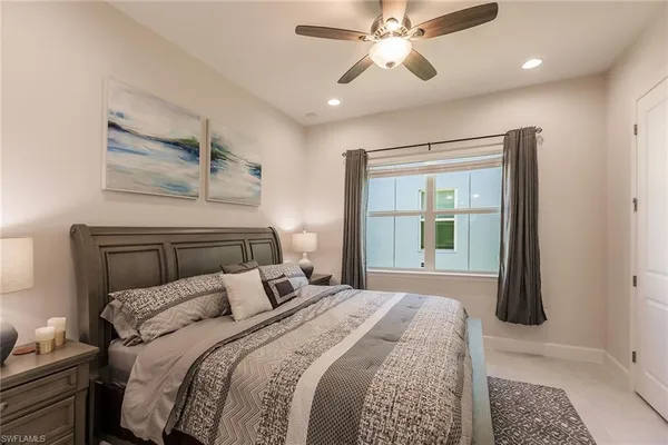 a bedroom with a large bed and a window