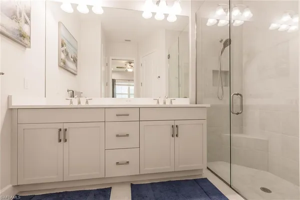 a bathroom with a shower sink and mirror