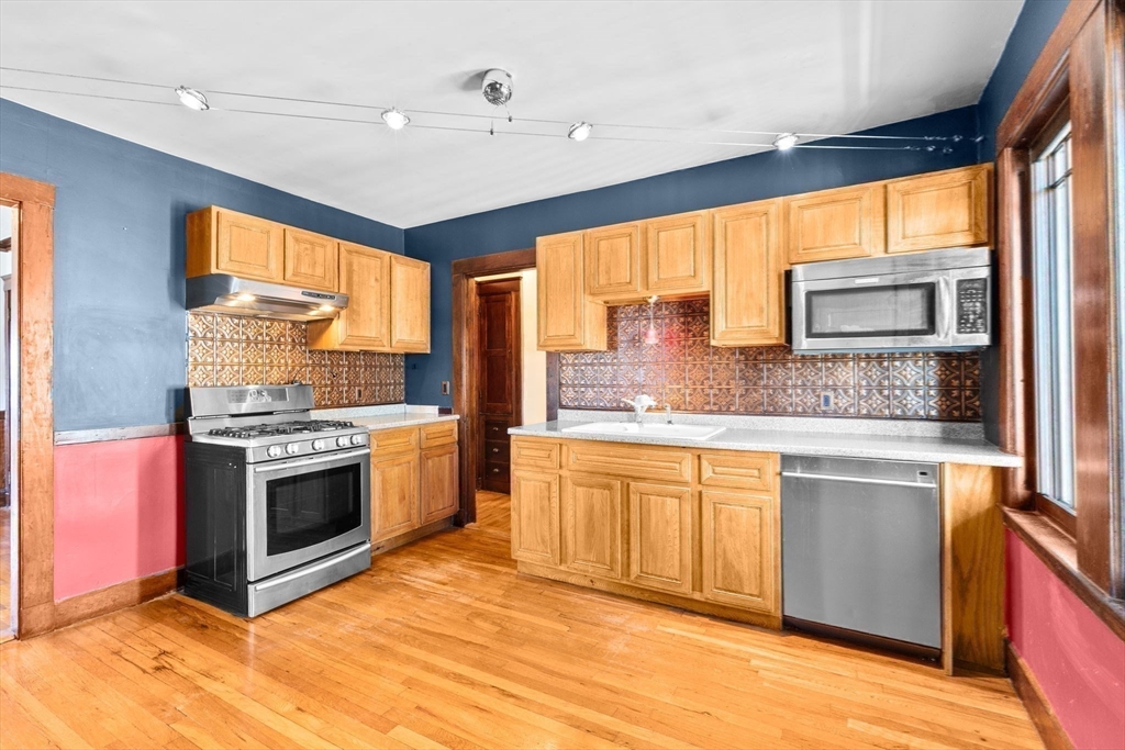 25 Whitby Terrace, Unit 3 Boston, MA 02125 - Photo 13 of 35 a kitchen with stainless steel appliances granite countertop a stove a sink and a refrigerator
